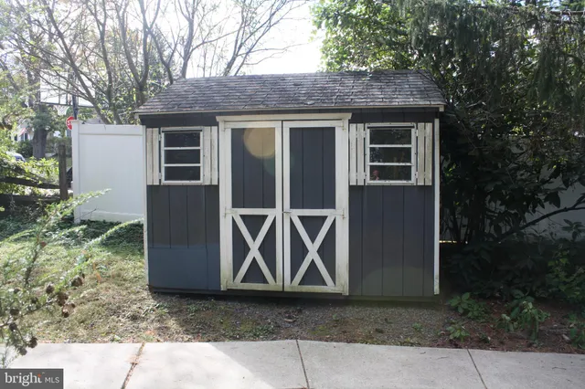 a view of a yard with snow on the road