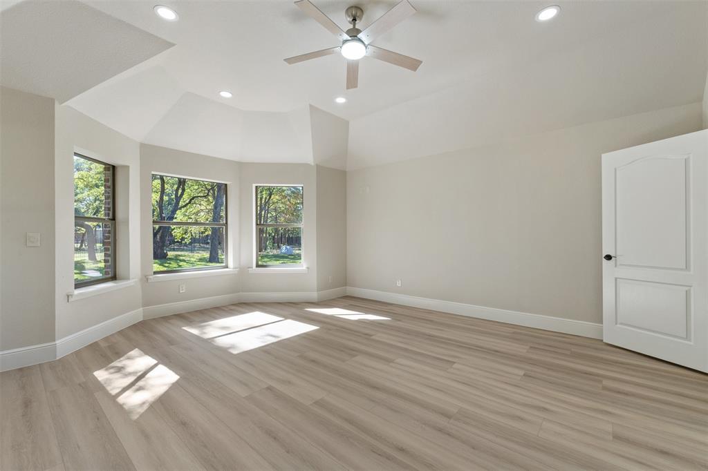 615 West Aurora Vista Trail Aurora, TX 76078 - Photo 17 of 40 an empty room with wooden floor and windows
