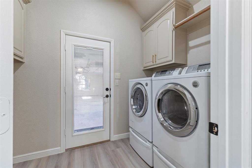 615 West Aurora Vista Trail Aurora, TX 76078 - Photo 27 of 40 a view of a hallway with washer and dryer