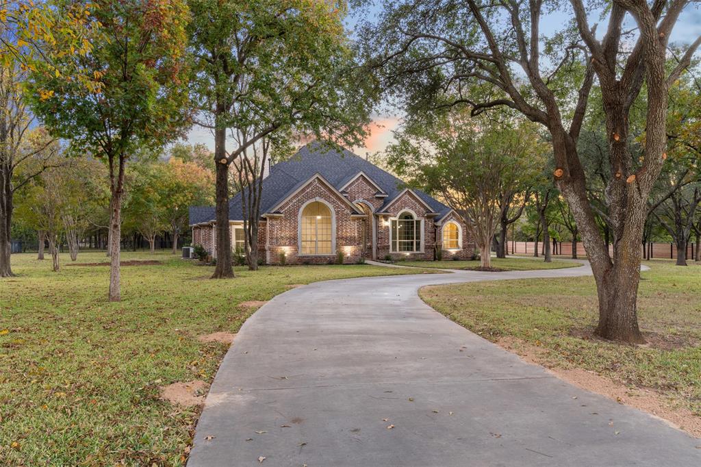615 West Aurora Vista Trail Aurora, TX 76078 - Photo 3 of 40 a front view of a house with garden