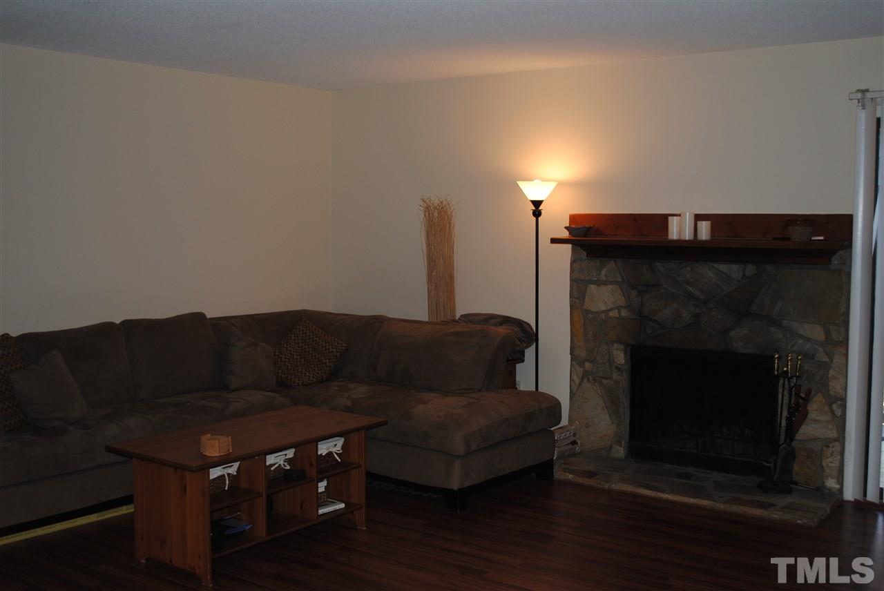 5408 Ridgeloch Place Raleigh, NC 27612 - Photo 11 of 25 a living room with furniture and a fireplace