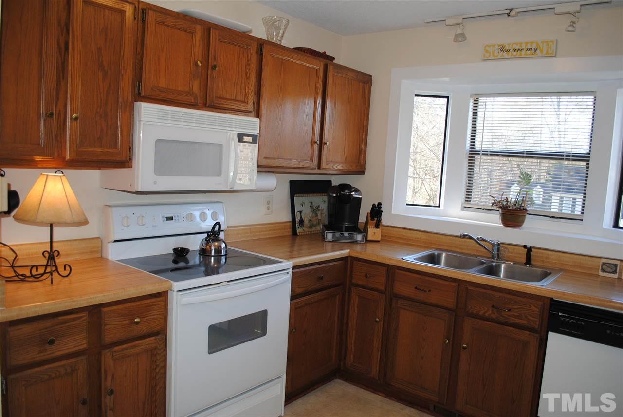 5408 Ridgeloch Place Raleigh, NC 27612 - Photo 12 of 25 a kitchen with a sink cabinets and window