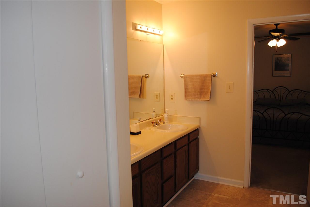 5408 Ridgeloch Place Raleigh, NC 27612 - Photo 19 of 25 a bathroom with a granite countertop sink a mirror and a shower