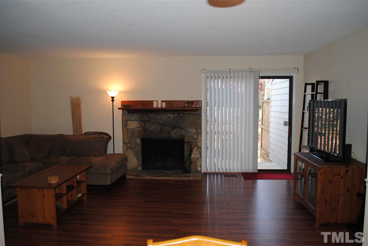 5408 Ridgeloch Place Raleigh, NC 27612 - Photo 7 of 25 a living room with furniture and a fireplace
