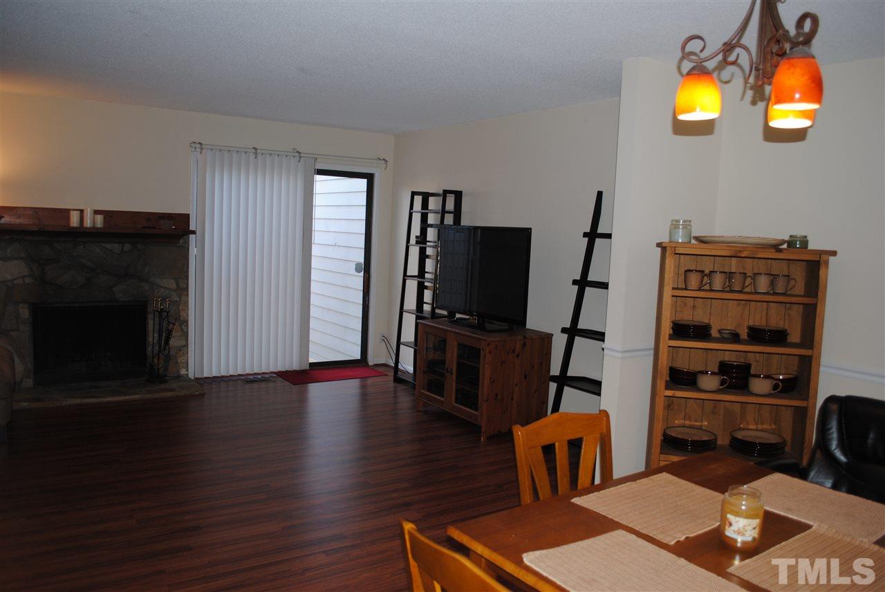 5408 Ridgeloch Place Raleigh, NC 27612 - Photo 8 of 25 a living room with furniture and a flat screen tv