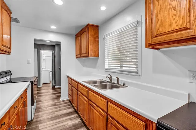 a kitchen with sink cabinets and a window