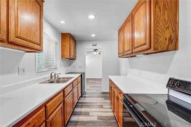 a kitchen with stainless steel appliances granite countertop a sink and a stove