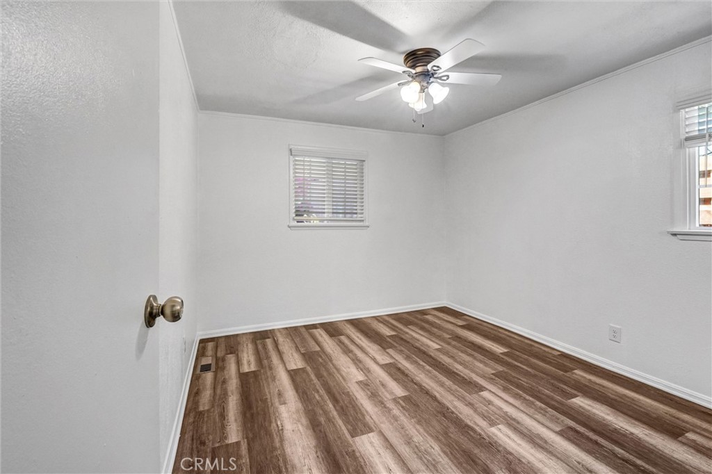 9246 Rowell Avenue Chatsworth, CA 91311 - Photo 16 of 22 an empty room with a chandelier fan and a window