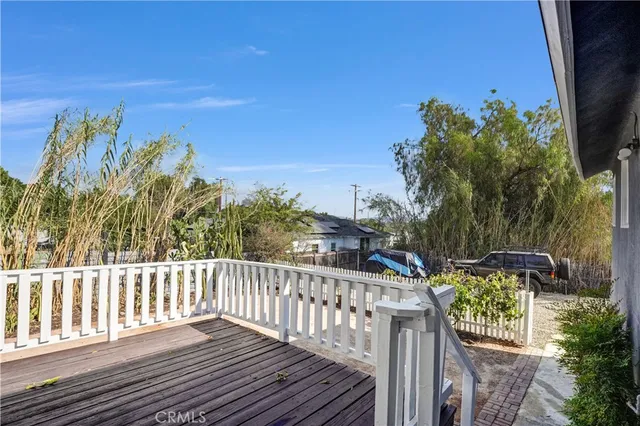 a view of a roof with wooden floor and fence