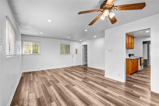 a view of a bedroom with a bed ceiling fan and window