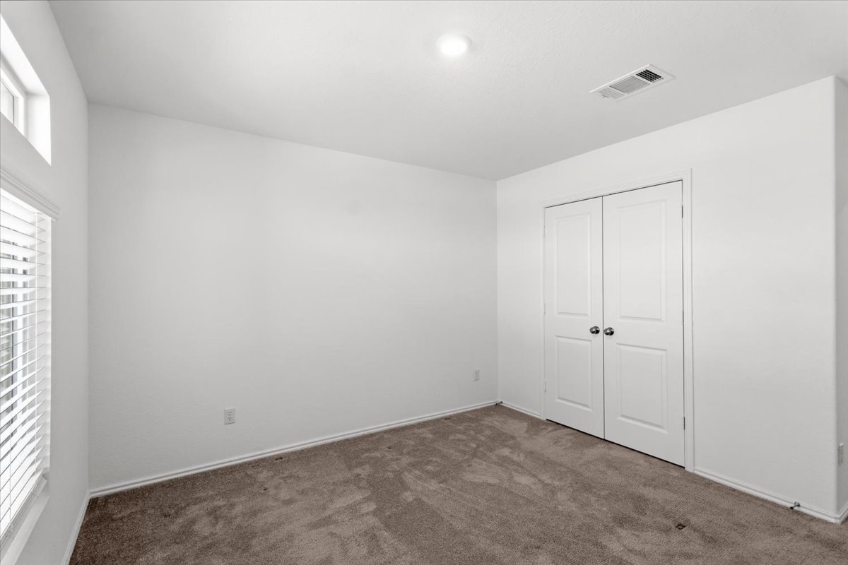 167 Jeffers Kyle, TX 78640 - Photo 12 of 40 Unfurnished bedroom with dark carpet and a closet