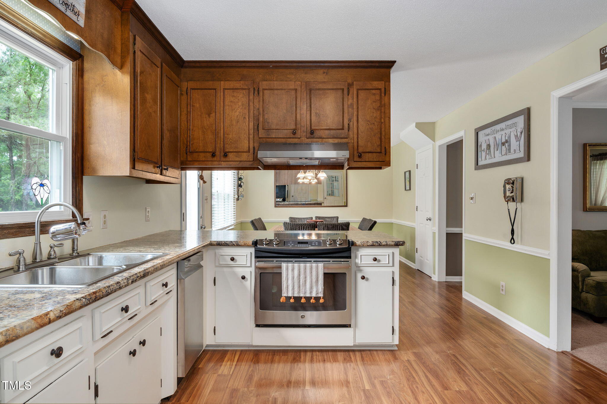 124 Windmere Drive Angier, NC 27501 - Photo 18 of 39 a kitchen with stainless steel appliances granite countertop a stove and a sink