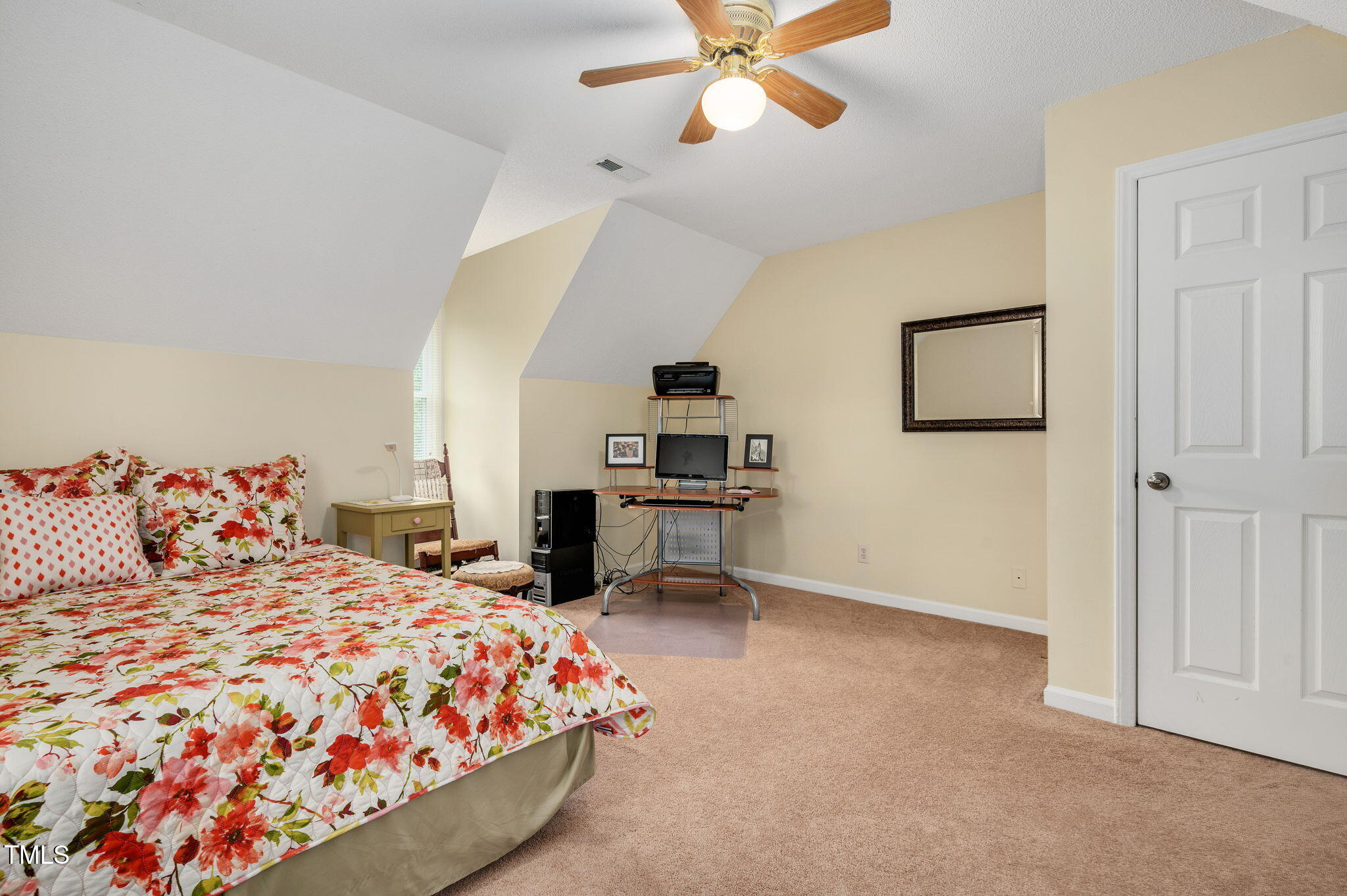 124 Windmere Drive Angier, NC 27501 - Photo 28 of 39 a bedroom with a large bed and a chandelier