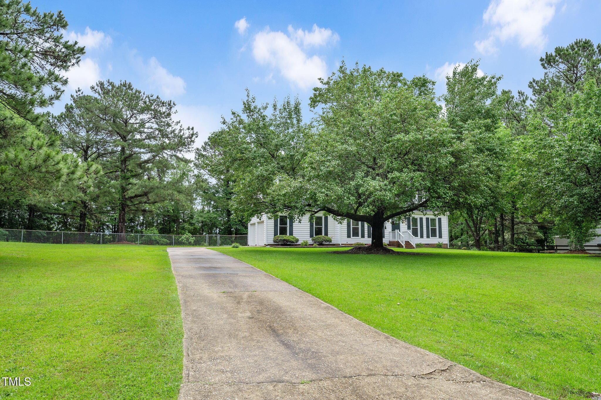 124 Windmere Drive Angier, NC 27501 - Photo 5 of 39 a view of a park with large trees and a wooden fence