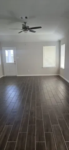 a view of a room with wooden floor and a sink