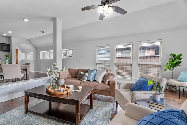 a living room with furniture potted plant and a window