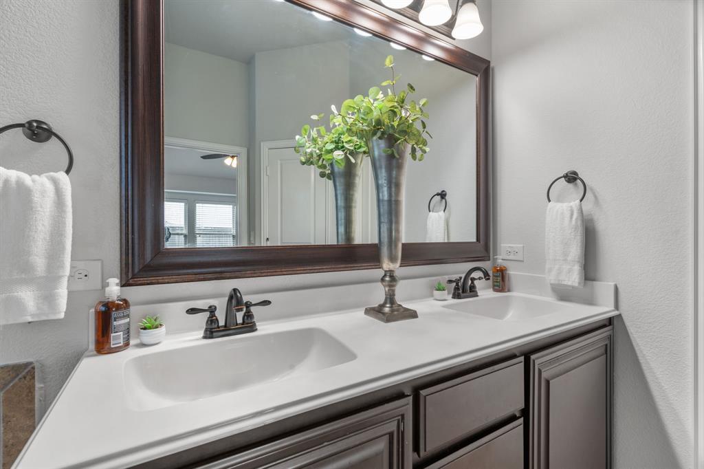 1609 Emerald Tree Place Aubrey, TX 76227 - Photo 18 of 39 a bathroom with a sink and a mirror