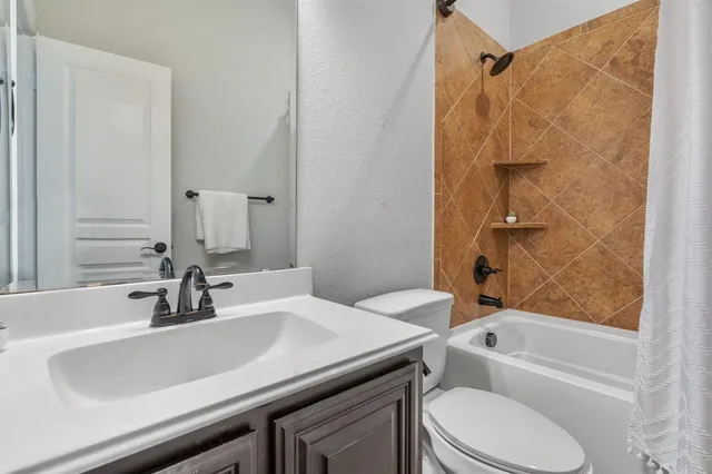 a bathroom with a sink a toilet and a bathtub