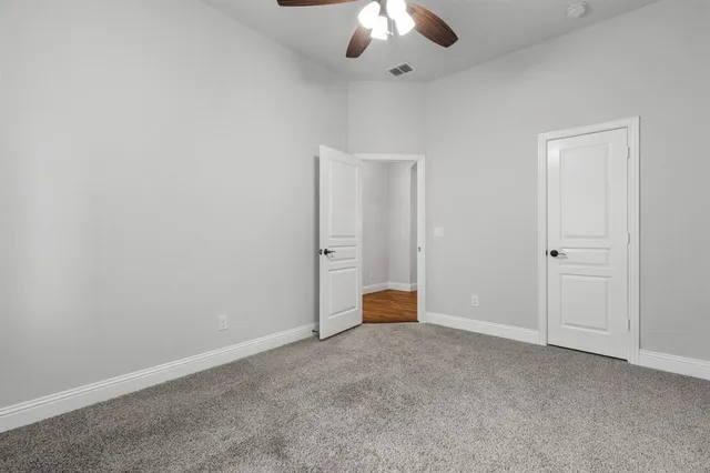 an empty room with a ceiling fan
