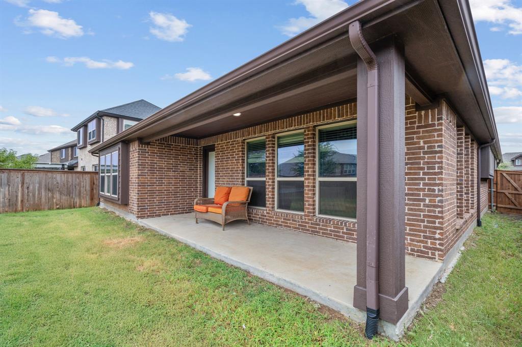 1609 Emerald Tree Place Aubrey, TX 76227 - Photo 29 of 39 a view of a house with backyard and porch