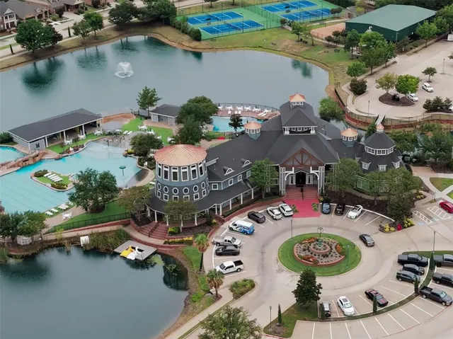 an aerial view of a house with swimming pool and outdoor space