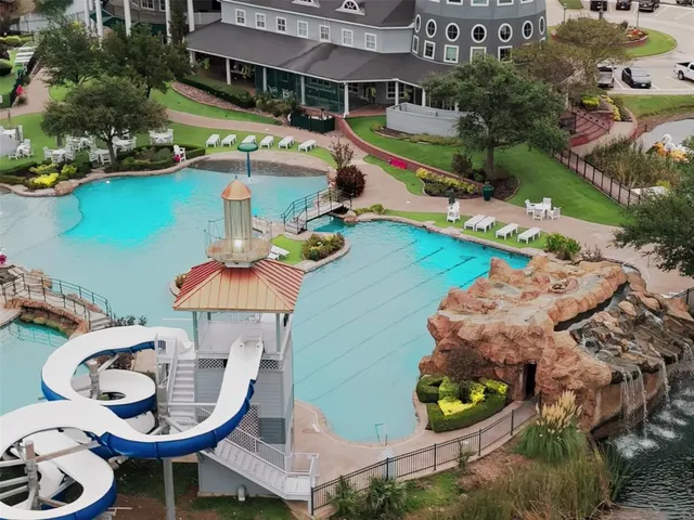 an aerial view of a house with swimming pool and outdoor seating
