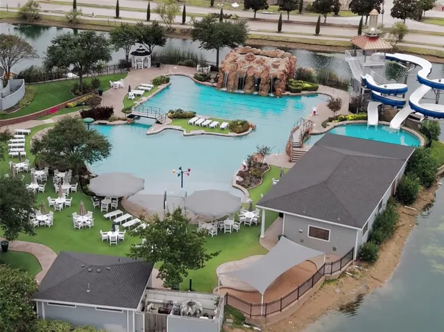 an aerial view of a house with garden space and street view