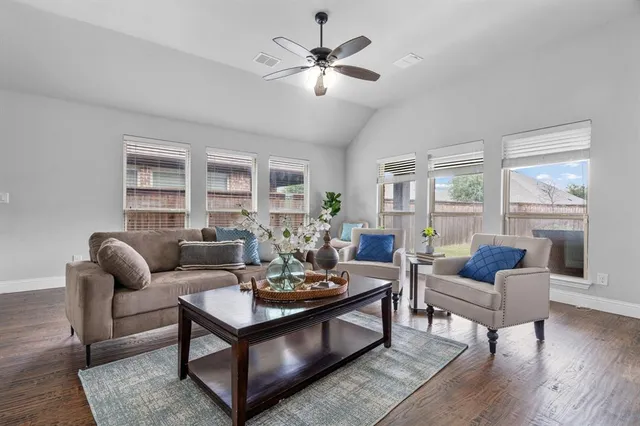 a living room with furniture and wooden floor