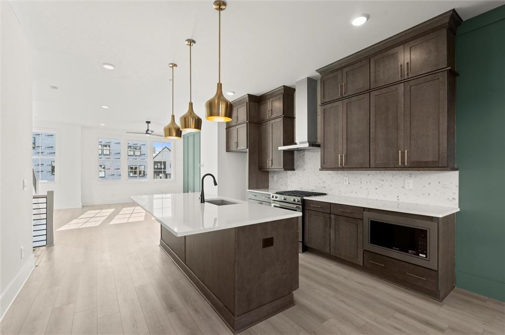 437 Mezzo Lane, Unit 87 Alpharetta, GA 30009 - Photo 11 of 46 a kitchen with stainless steel appliances granite countertop a sink a stove and a wooden floors