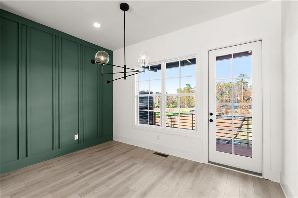 437 Mezzo Lane, Unit 87 Alpharetta, GA 30009 - Photo 12 of 46 a view of an empty room with a window and wooden floor