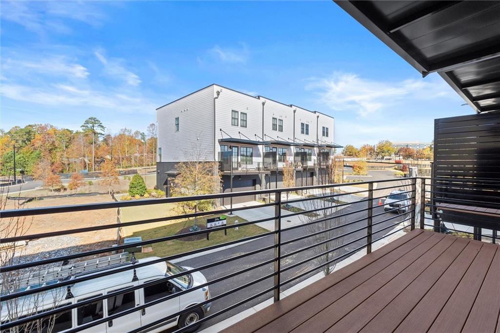 437 Mezzo Lane, Unit 87 Alpharetta, GA 30009 - Photo 13 of 46 a view of a balcony with wooden floor and city view