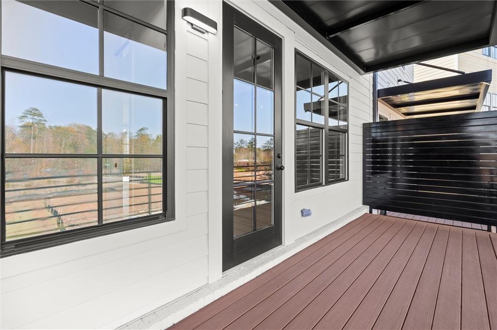 437 Mezzo Lane, Unit 87 Alpharetta, GA 30009 - Photo 14 of 46 a view of a porch with wooden floor and floor to ceiling window