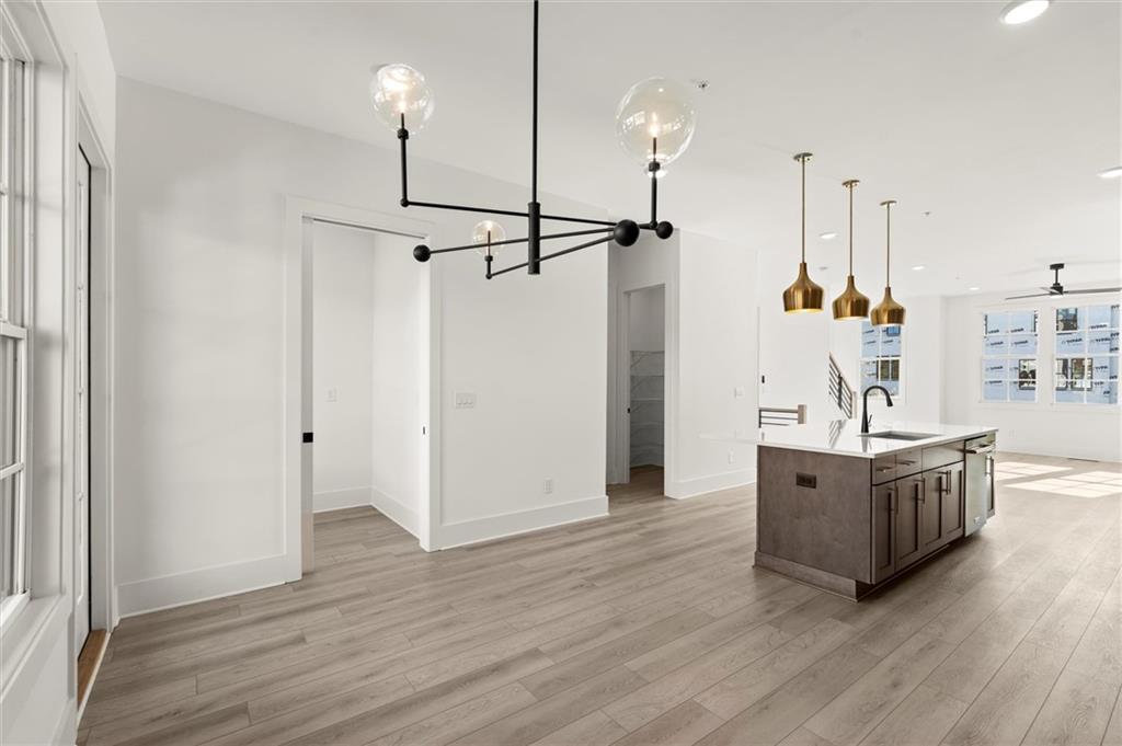 437 Mezzo Lane, Unit 87 Alpharetta, GA 30009 - Photo 16 of 46 a living room with stainless steel appliances furniture wooden floor and a chandelier