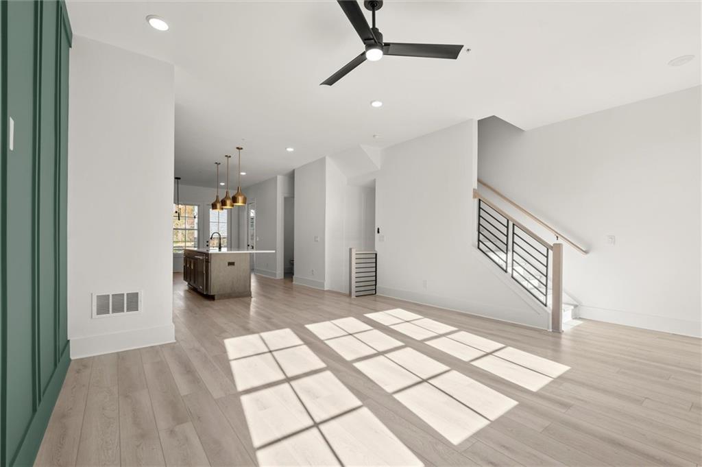 437 Mezzo Lane, Unit 87 Alpharetta, GA 30009 - Photo 20 of 46 a view of a hallway with wooden floor and a living room