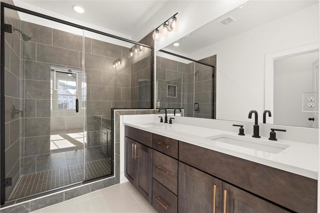 437 Mezzo Lane, Unit 87 Alpharetta, GA 30009 - Photo 25 of 46 a bathroom with a double vanity sink and mirror