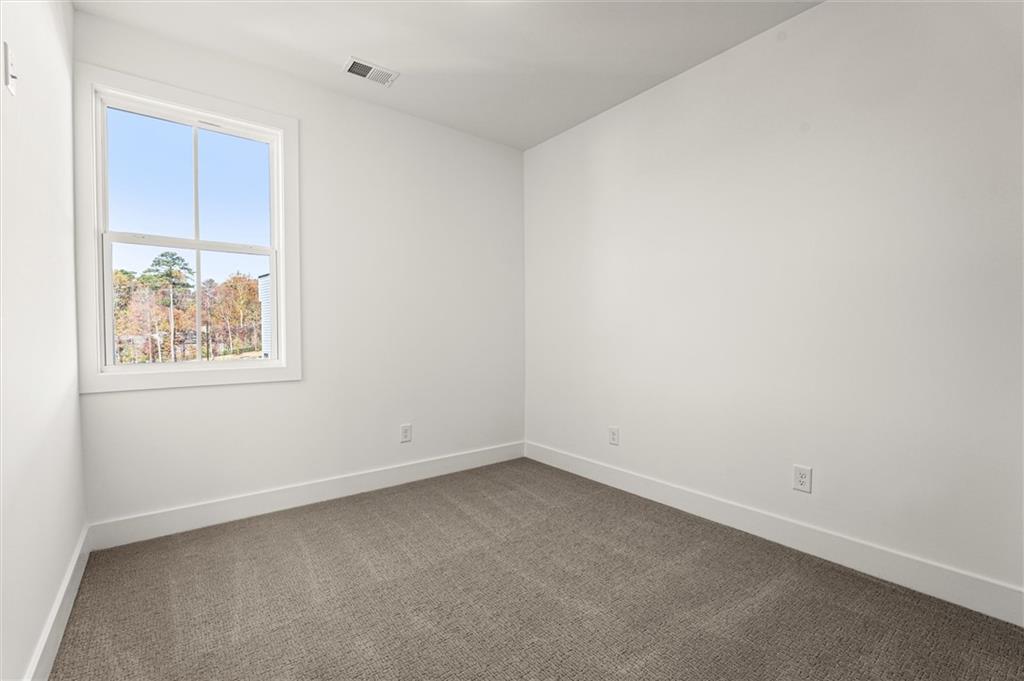 437 Mezzo Lane, Unit 87 Alpharetta, GA 30009 - Photo 28 of 46 an empty room with a workbench