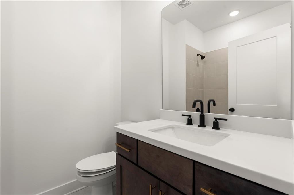 437 Mezzo Lane, Unit 87 Alpharetta, GA 30009 - Photo 32 of 46 a bathroom with a sink a toilet a mirror and vanity