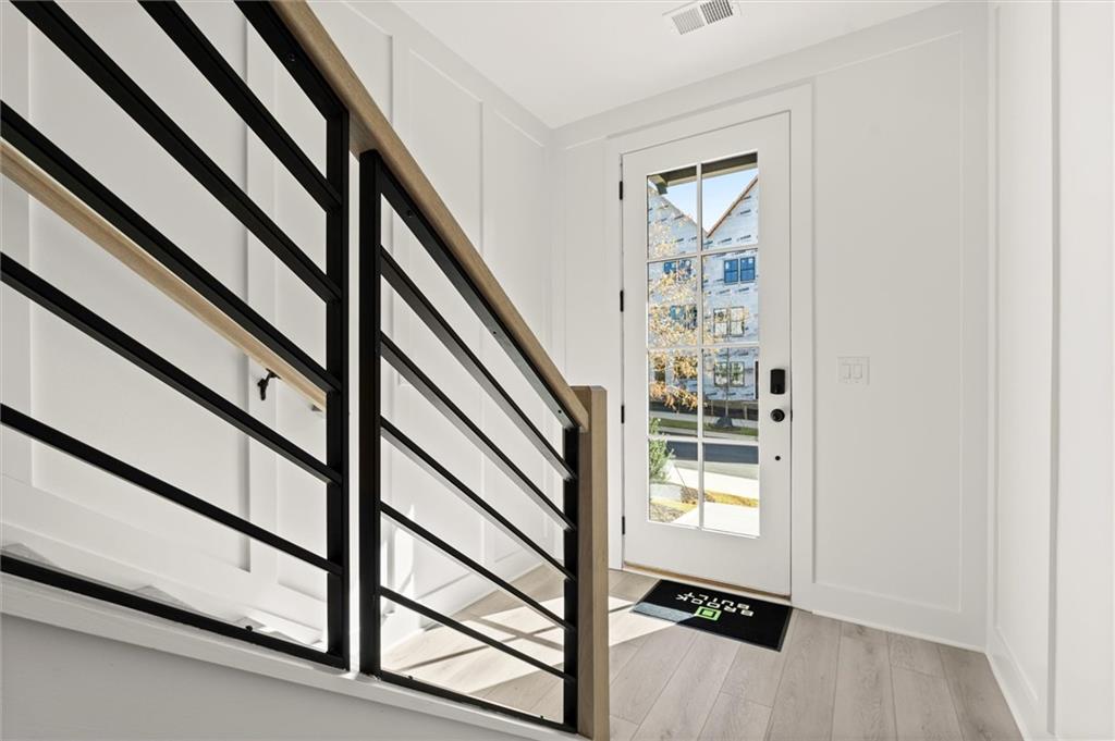 437 Mezzo Lane, Unit 87 Alpharetta, GA 30009 - Photo 7 of 46 a view of staircase with wooden floor and a window
