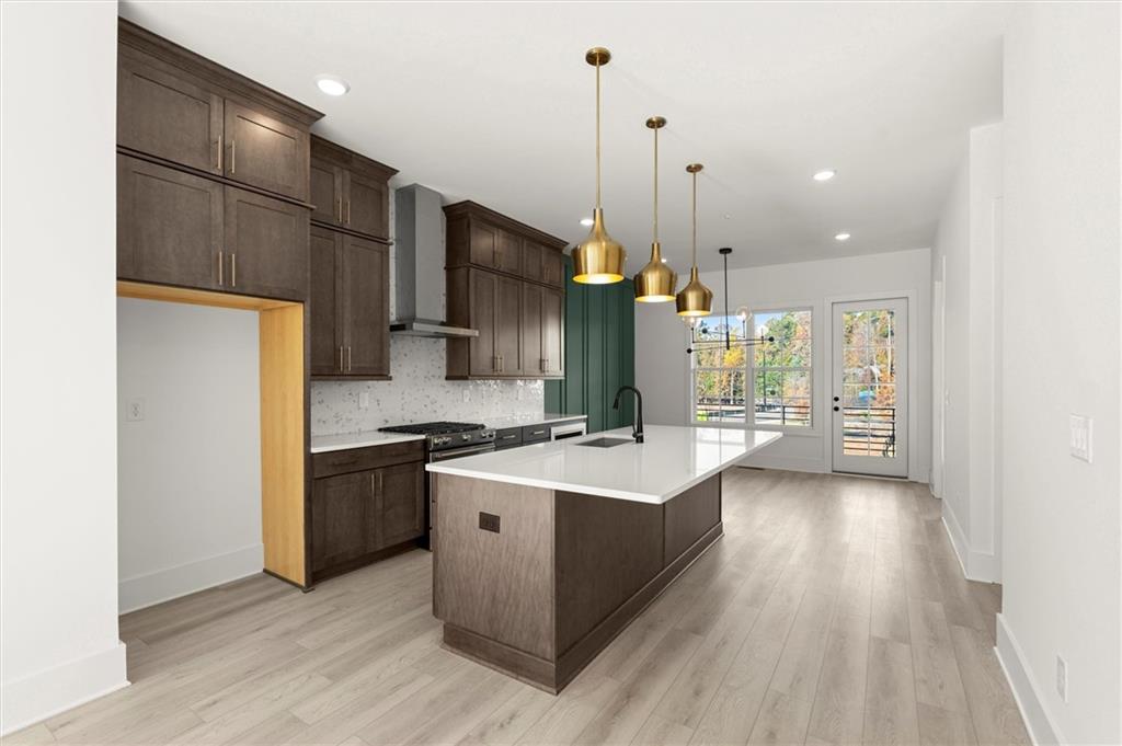 437 Mezzo Lane, Unit 87 Alpharetta, GA 30009 - Photo 8 of 46 a kitchen with stainless steel appliances a stove refrigerator and wooden floor