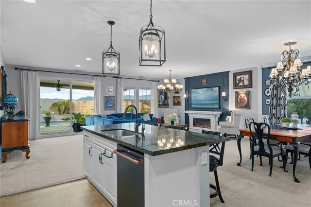 a kitchen with center island table and chairs