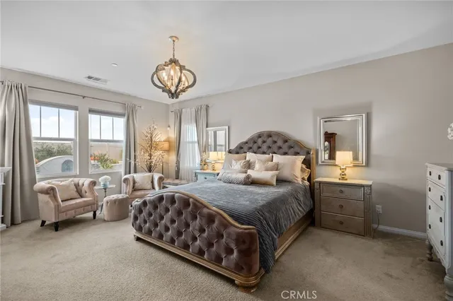 a bedroom with a large bed and a large window