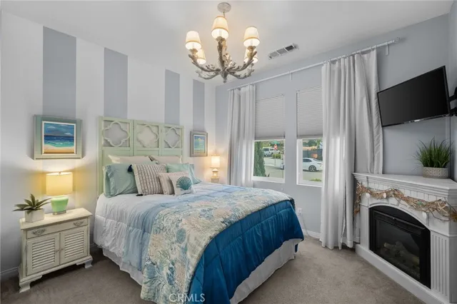 a bedroom with a large bed and a flat tv screen on dresser