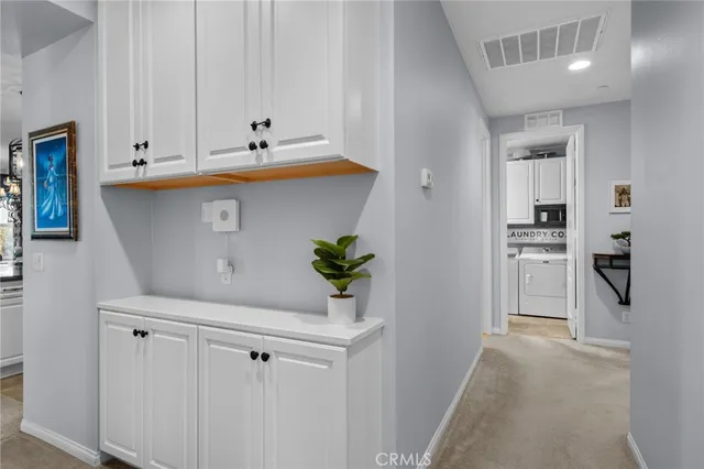 a view of kitchen with white cabinets