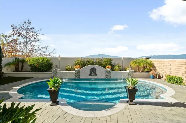 a view of a swimming pool with an outdoor seating and a yard