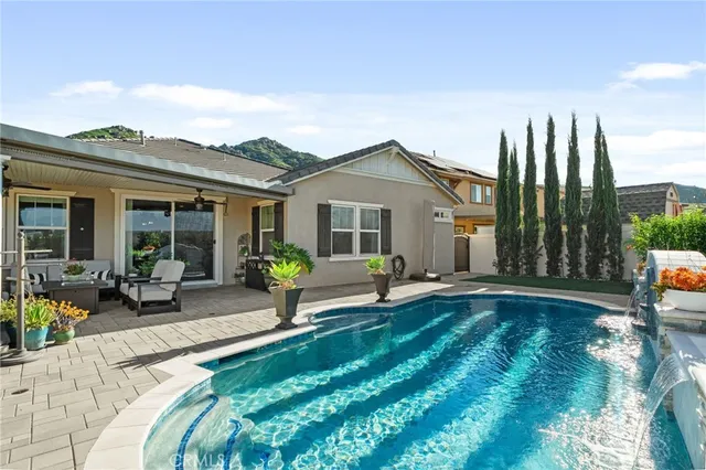 a view of a house with backyard sitting area and porch
