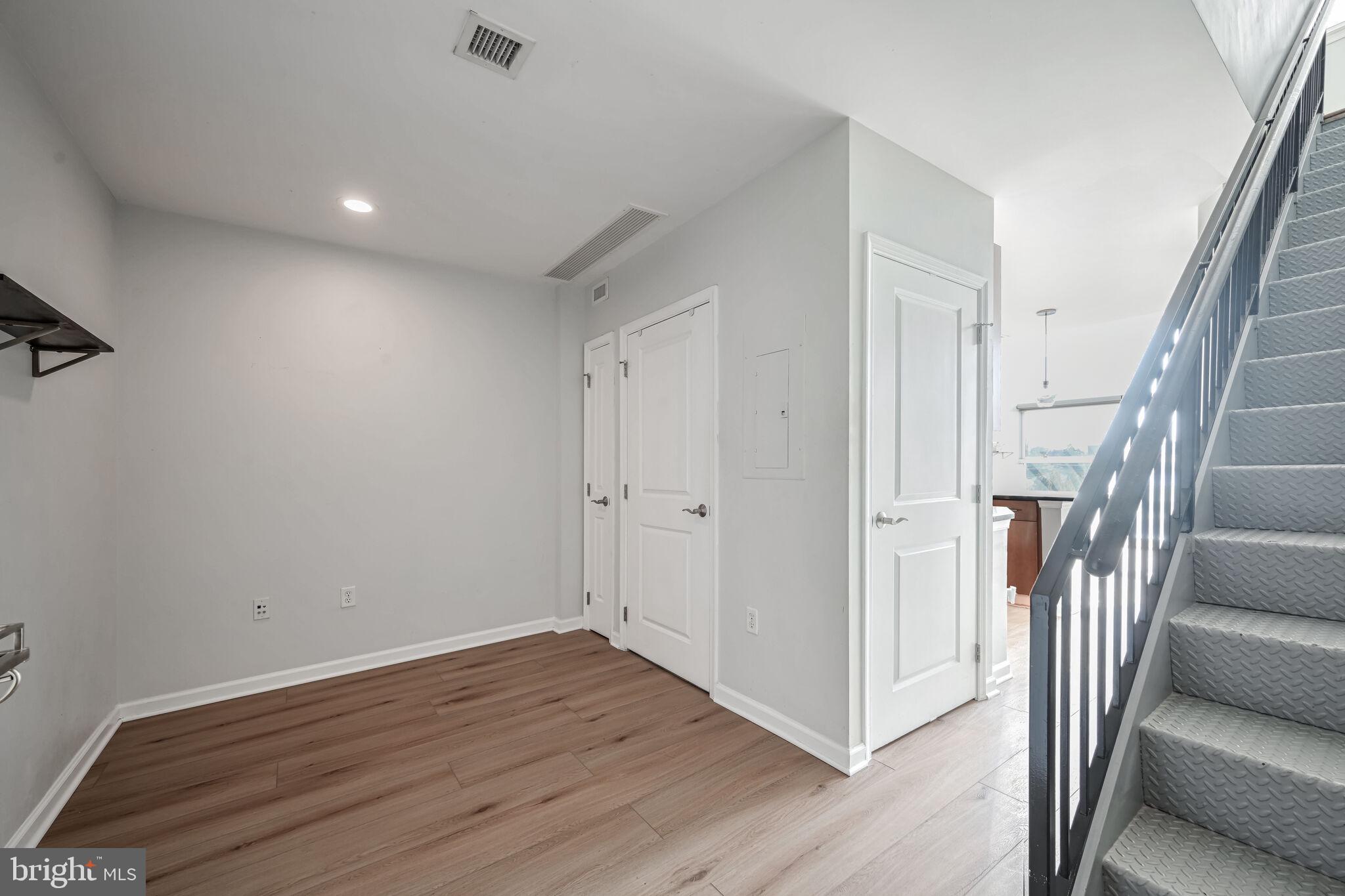 444 West Broad Street, Unit 619 Falls Church, VA 22046 - Photo 4 of 21 a view of a hallway with wooden floor and stairs