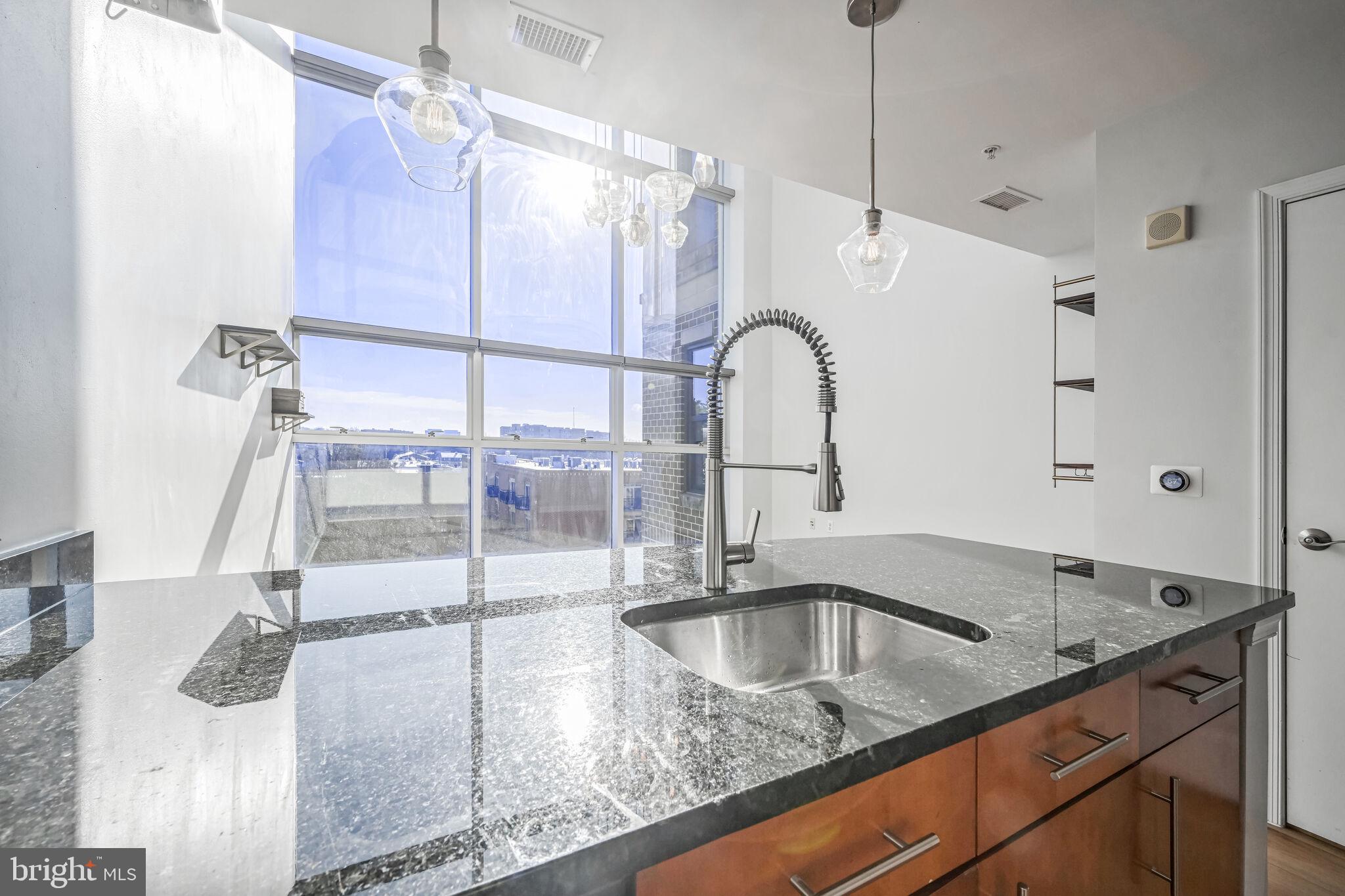 444 West Broad Street, Unit 619 Falls Church, VA 22046 - Photo 5 of 21 a kitchen with a sink a counter top space and cabinets