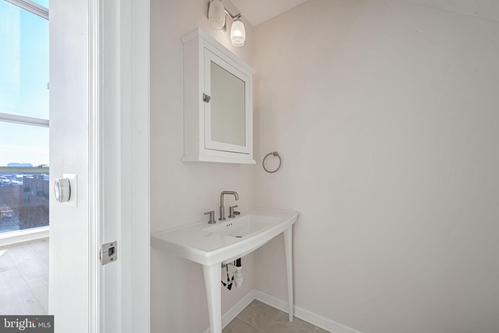 444 West Broad Street, Unit 619 Falls Church, VA 22046 - Photo 9 of 21 a bathroom with a sink vanity and a mirror