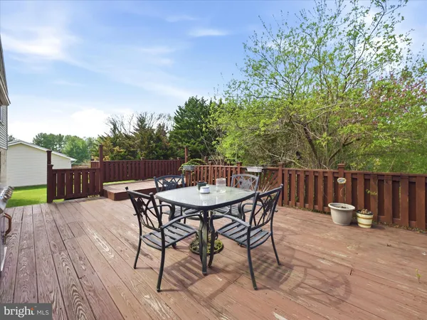 a view of backyard with furniture and wooden floor
