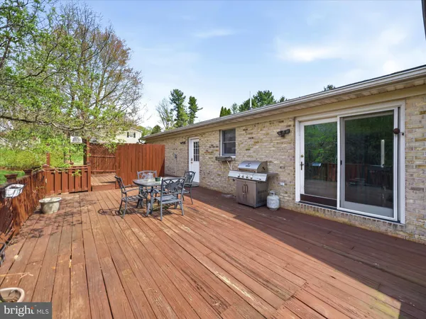 a view of a deck with table and chairs with wooden floor and fence